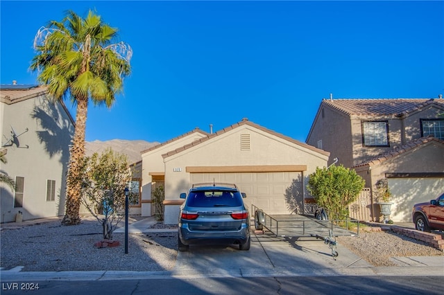 view of front of property featuring a garage and a mountain view