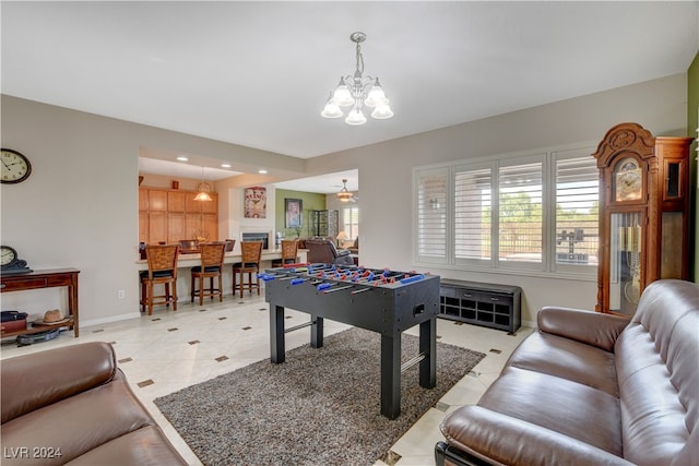 game room with a notable chandelier and light tile patterned flooring