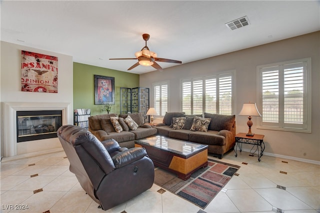 living room featuring light tile patterned flooring and ceiling fan