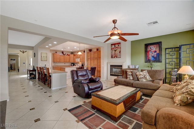 tiled living room with ceiling fan