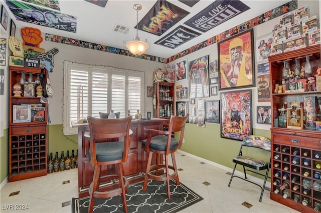 bar with tile patterned floors and decorative light fixtures