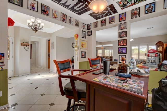 dining area with a chandelier and light tile patterned floors