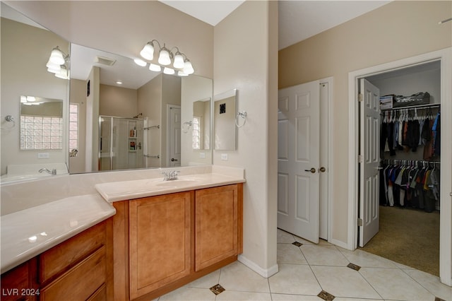 bathroom with vanity, tile patterned floors, and a shower with door