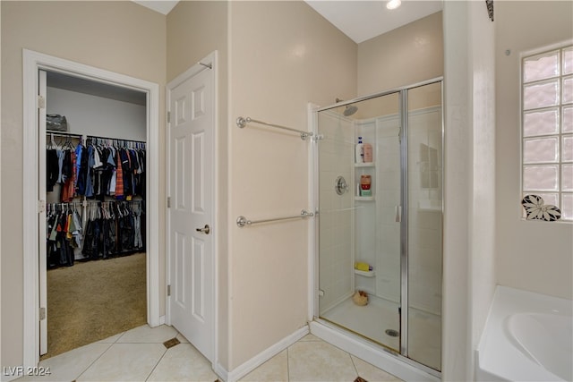 bathroom featuring a wealth of natural light, plus walk in shower, and tile patterned flooring