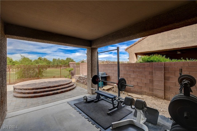 exercise room featuring concrete flooring