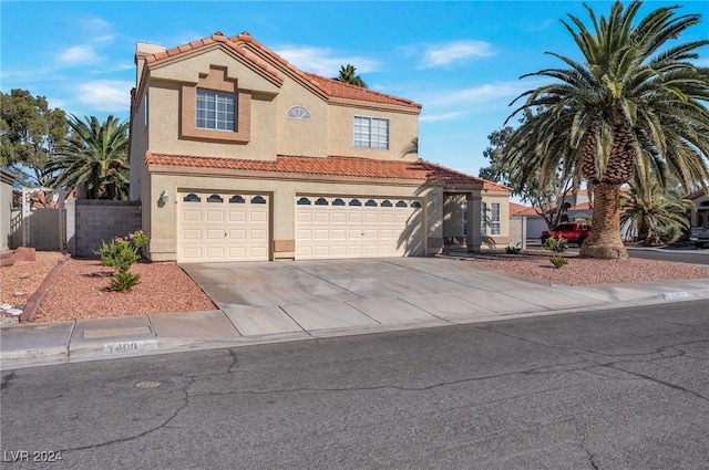 mediterranean / spanish-style home with a garage