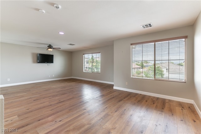 spare room with hardwood / wood-style flooring and ceiling fan