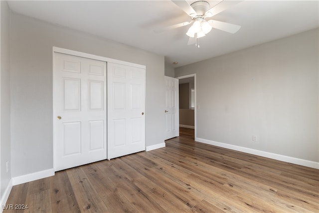 unfurnished bedroom with ceiling fan, a closet, and light hardwood / wood-style flooring