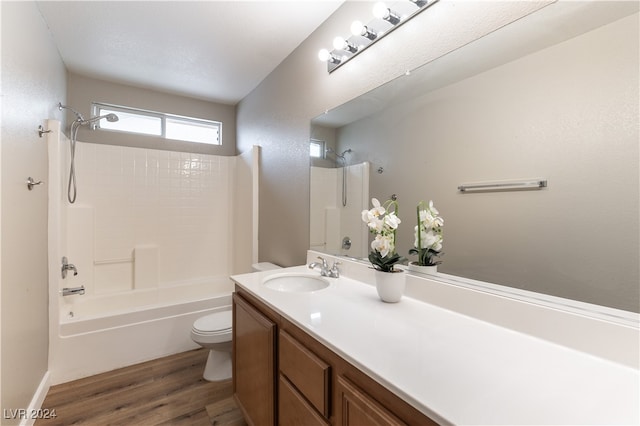 full bathroom with toilet, shower / bath combination, vanity, and hardwood / wood-style floors