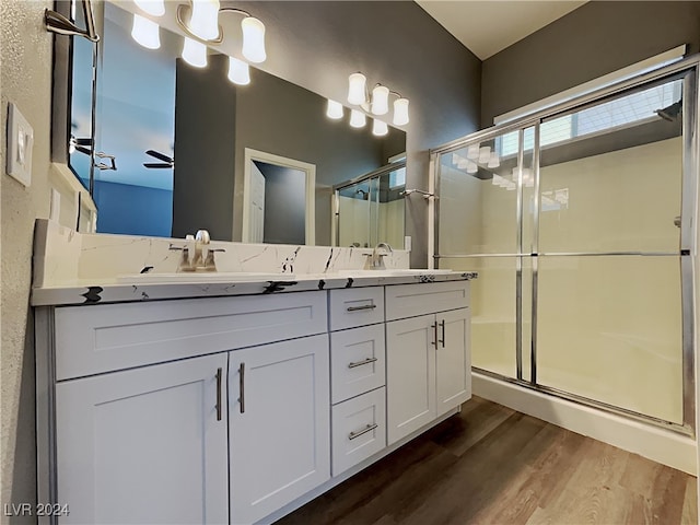 bathroom featuring hardwood / wood-style flooring, vanity, ceiling fan, and a shower with shower door