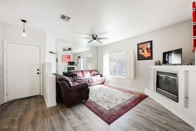 living room featuring dark hardwood / wood-style floors and ceiling fan