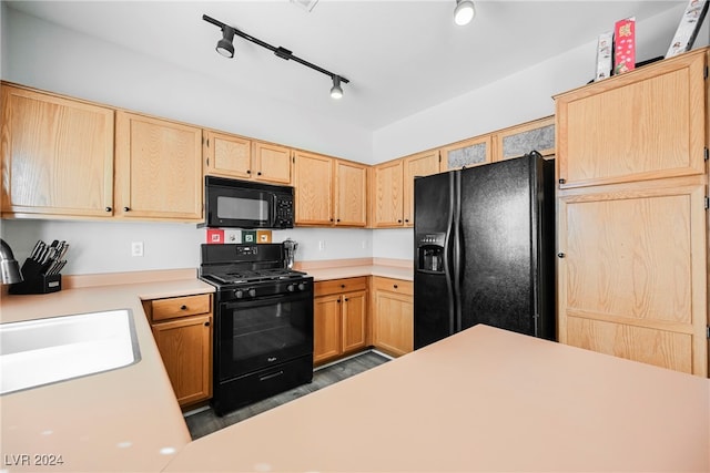 kitchen featuring track lighting, light brown cabinetry, dark hardwood / wood-style floors, black appliances, and sink