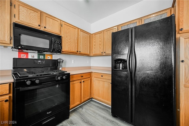 kitchen with black appliances and light wood-type flooring