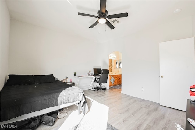 bedroom featuring connected bathroom, light wood-type flooring, and ceiling fan