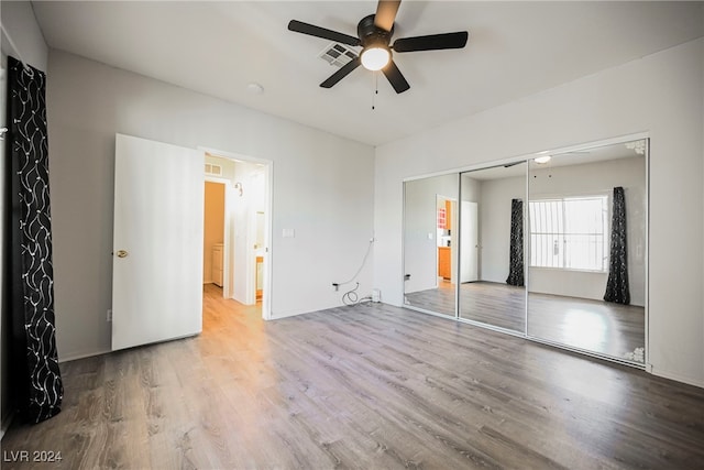 unfurnished bedroom featuring a closet, ceiling fan, and hardwood / wood-style flooring