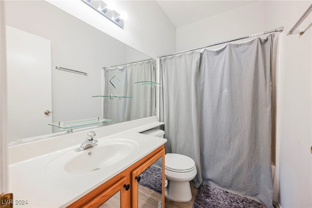 full bathroom with toilet, hardwood / wood-style floors, vanity, and shower / bathtub combination with curtain