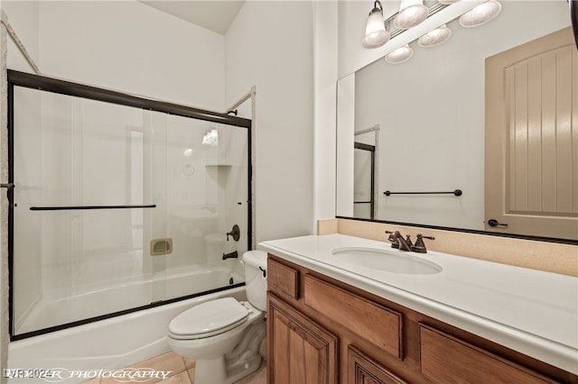 full bathroom with vanity, shower / bath combination with glass door, toilet, and tile patterned flooring