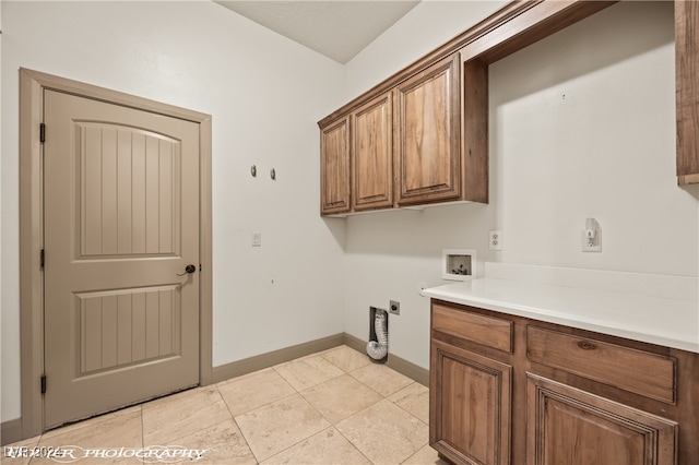 clothes washing area featuring light tile patterned floors, washer hookup, hookup for an electric dryer, and cabinets