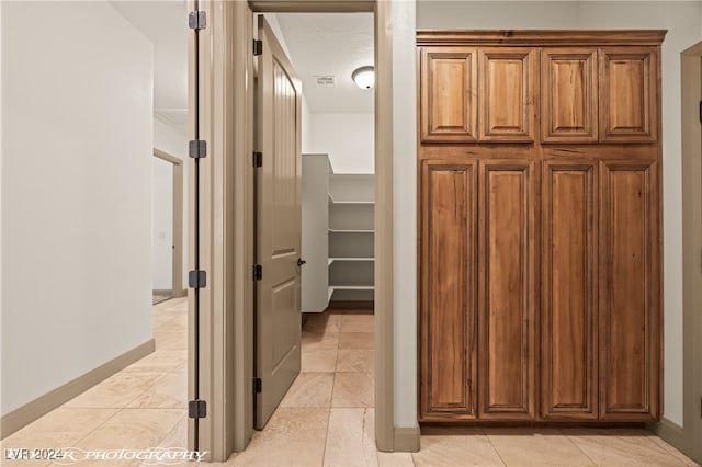 hallway featuring light tile patterned floors