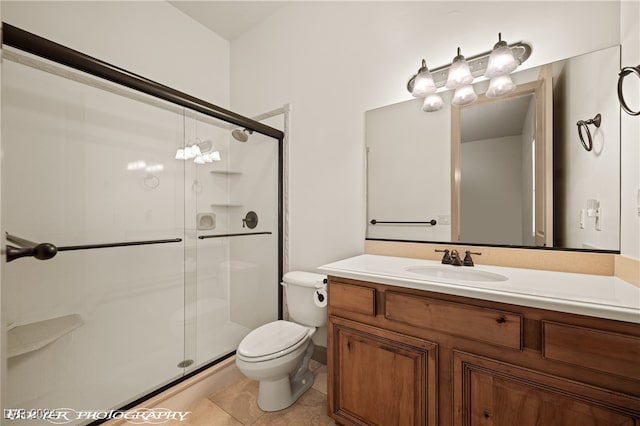 bathroom featuring vanity, toilet, walk in shower, and tile patterned flooring