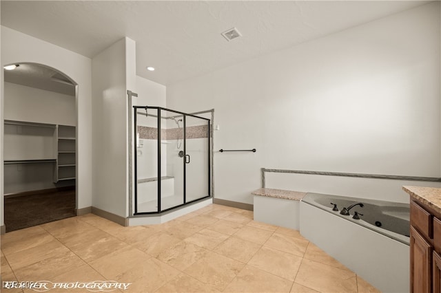 bathroom featuring vanity, tile patterned floors, and shower with separate bathtub