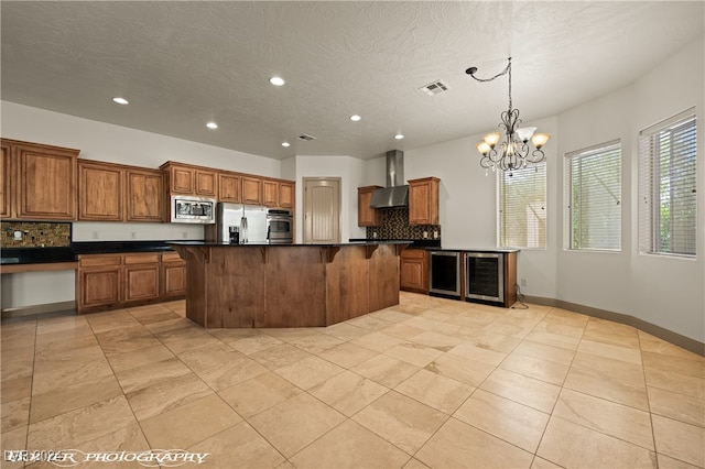 kitchen with backsplash, a center island, decorative light fixtures, appliances with stainless steel finishes, and a textured ceiling