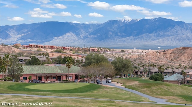 view of community with a yard and a mountain view