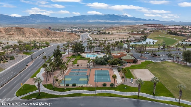 drone / aerial view featuring a water and mountain view