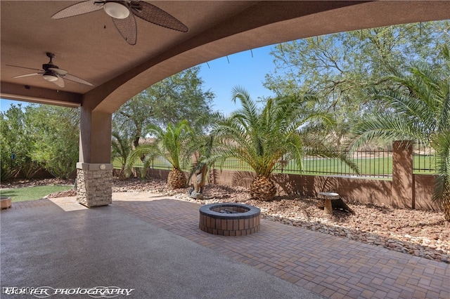 view of patio / terrace featuring ceiling fan and a fire pit