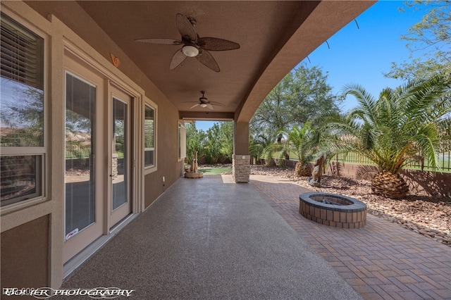 view of patio / terrace with a fire pit and ceiling fan