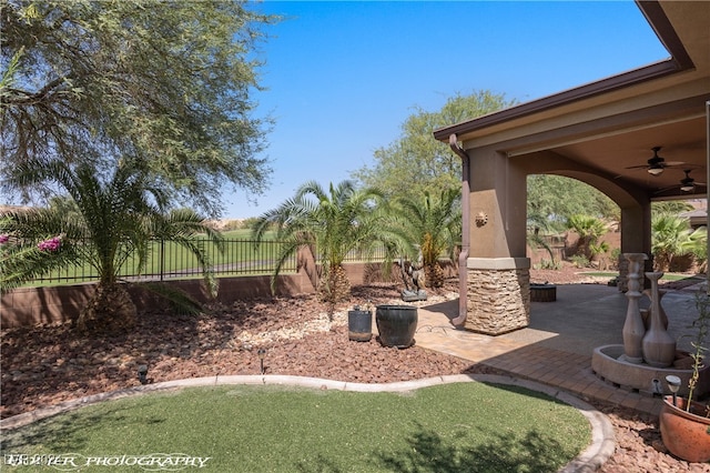 view of yard featuring a patio area and ceiling fan