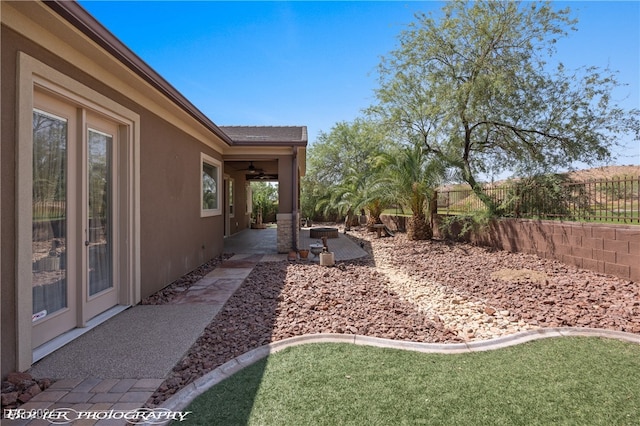 view of yard with a patio area and ceiling fan