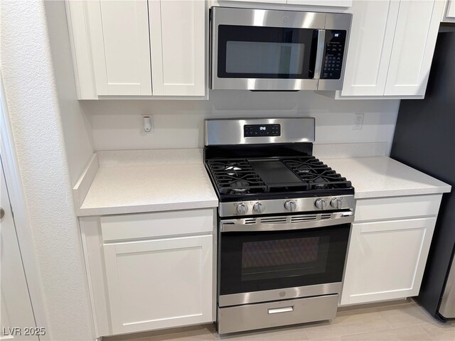 kitchen featuring white cabinets and appliances with stainless steel finishes