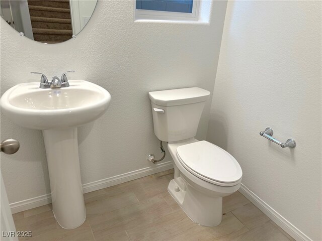 bathroom with tile patterned flooring, toilet, and sink