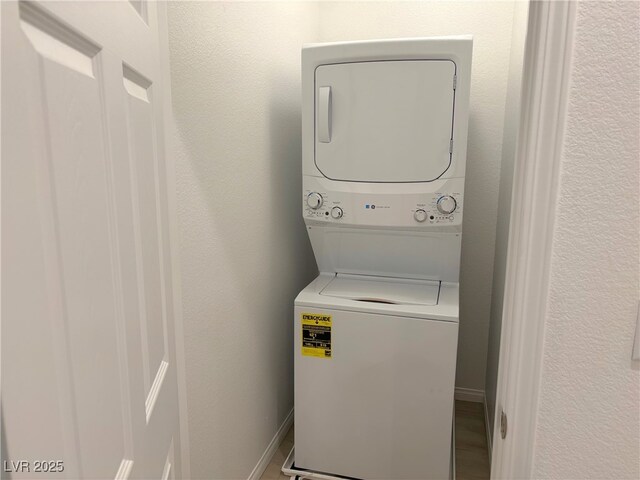 laundry area with stacked washer and dryer