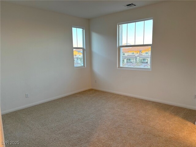 empty room with light colored carpet