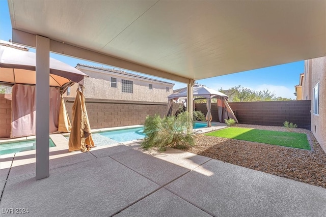 view of patio with a gazebo and a fenced in pool