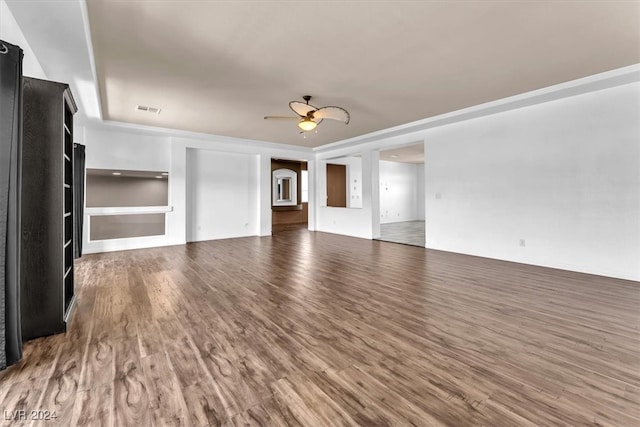 unfurnished living room with dark hardwood / wood-style floors and ceiling fan