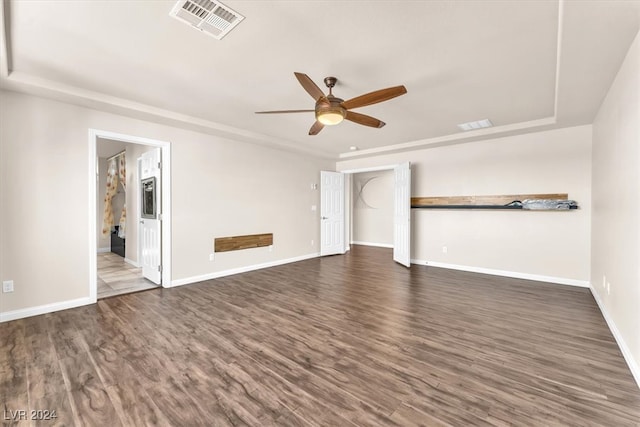 unfurnished living room featuring ceiling fan and dark hardwood / wood-style flooring