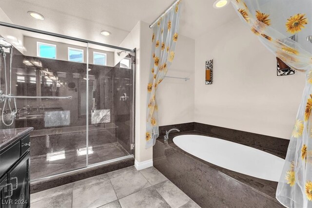 bathroom featuring vanity and shower with separate bathtub