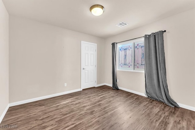 unfurnished room featuring dark hardwood / wood-style floors