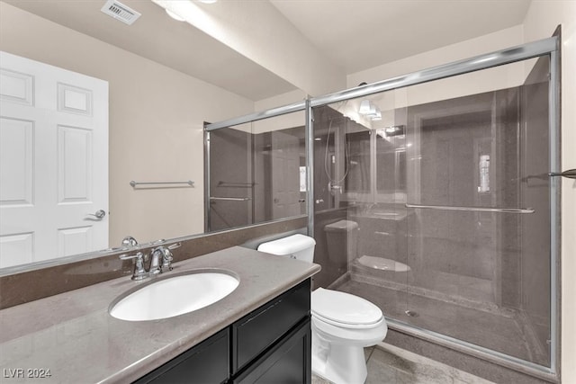 bathroom with vanity, toilet, and an enclosed shower