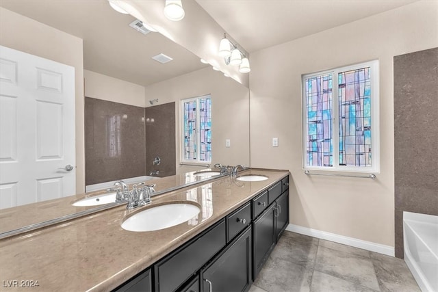 bathroom with vanity and a washtub