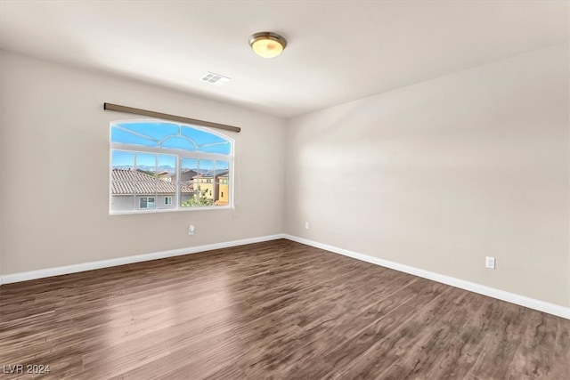 unfurnished room featuring dark hardwood / wood-style floors