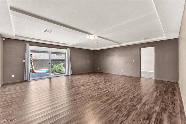 empty room with hardwood / wood-style floors and a textured ceiling