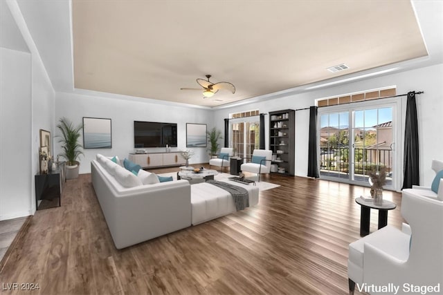 living room featuring ceiling fan and hardwood / wood-style flooring