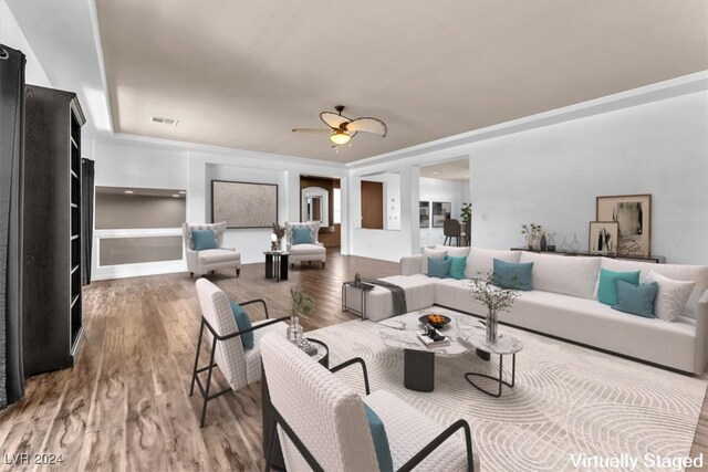 living room with wood-type flooring and ceiling fan