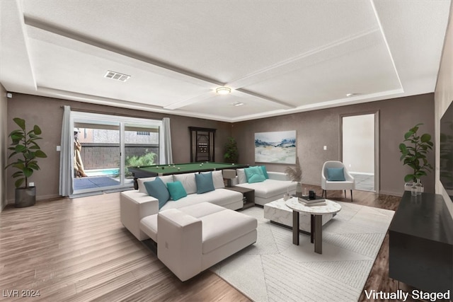 living room with hardwood / wood-style flooring, a textured ceiling, and pool table