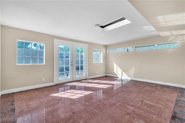 unfurnished room featuring french doors