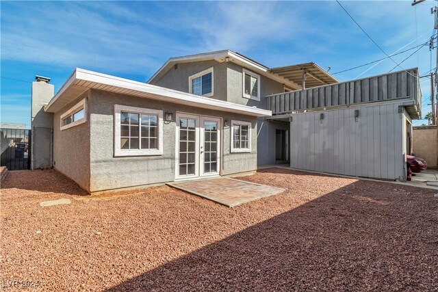 rear view of house featuring french doors and a patio area